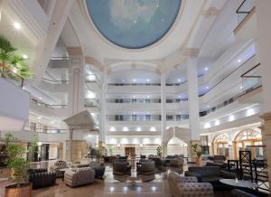 a lobby with couches and chairs in a building at Adora Hotel & Resort in Belek