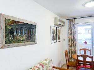 una sala de estar con una pintura en la pared en Acogedor SierraMar 1era Línea, en Oropesa del Mar