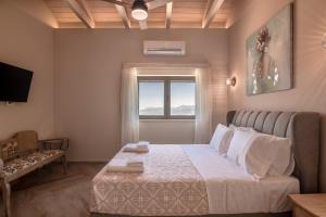 a small bedroom with a bed and a window at Alexandras's Mansion in Ayiá +212 photos