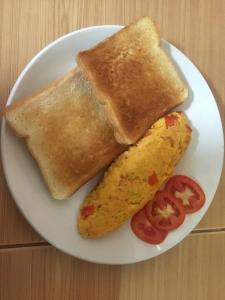 a plate with two pieces of toast and a burrito at Smile Resort Koh Mook in Ko Mook