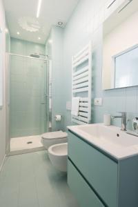 a white bathroom with a toilet and a sink at VIVO in Civitanova Marche