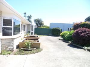 a house with a pathway leading into a yard at Warm & welcome on Whiteley in New Plymouth