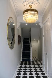 a hallway with a chandelier and a checkerboard floor at MOXIE LUXURY APARTMENTS in Belfast