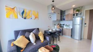 a living room with a couch and a kitchen at A404-nice Seaview One Bedroom At Ao Nang Beach in Ao Nang Beach