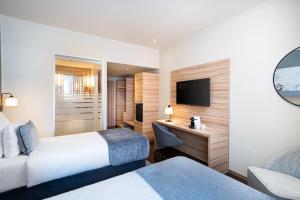 Posteľ alebo postele v izbe v ubytovaní Leonardo Hotel Vienna Hauptbahnhof