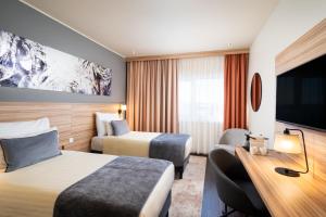 Posteľ alebo postele v izbe v ubytovaní Leonardo Hotel Vienna Hauptbahnhof