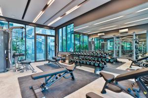 a gym with rows of exercise equipment and windows at A404-nice Seaview One Bedroom At Ao Nang Beach in Ao Nang Beach