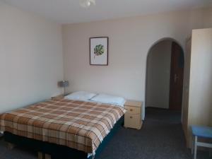 une chambre d'hôtel avec un lit et une photo sur le mur dans l'établissement Pokoje Gościnne Kaja, à Kudowa-Zdrój