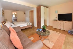 a living room with a couch and a bed at Appartement Zint in Sankt Gallenkirch