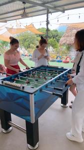 a group of women standing around a table with a Bay H Hbestosbestosbestos at Nhà Gỗ An Trăm Tuổi - Chill Garden Lakeview in Hanoi