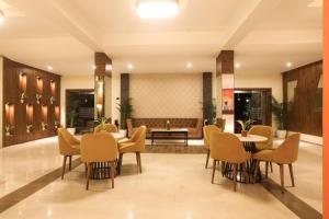 a lobby of a hotel with tables and chairs at IRA by Orchid, Nashik in Nashik