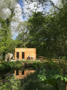 a wooden cabin in the middle of a forest at Rivendell Bothan in Spean Bridge