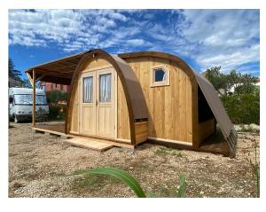 a large wooden building with a gazebo at MALI NORDSEE Mobilehomes , Glamping & Caravan in Pakoštane