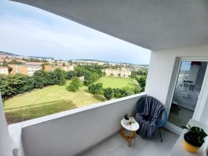 a balcony with a view of a green yard at Panoramic City View Apartment in Târgu-Mureş