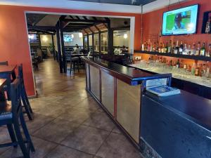 a bar in a restaurant with tables and chairs at Angels Resort in Porvorim