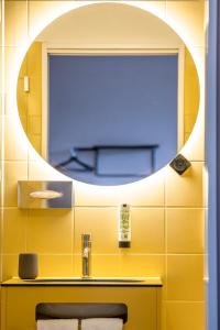 a bathroom with a sink and a mirror at Kloster by b-smart in Schaan +20 photos
