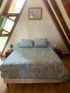 a bedroom with a bed in a attic at Chalet de vacances au bord de mer VER SUR MER in Ver-sur-Mer