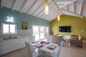 a kitchen and living room with a table and chairs at Airport View 3-Bed Villa in Cupecoy