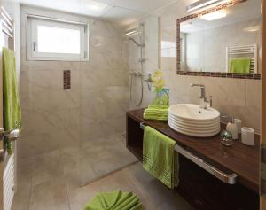 a bathroom with a sink and a shower at Appartement Zint in Sankt Gallenkirch