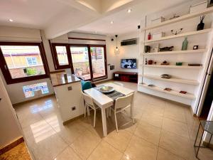 a kitchen and dining room with a table and chairs at Far Home Gran Vía in Madrid