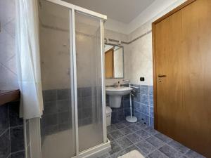 a bathroom with a shower and a sink and a toilet at 081 Trilocale Baldino, Pinzolo in Pinzolo