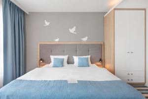 Una cama o camas en una habitación de AQUA Resort AQUAPARK