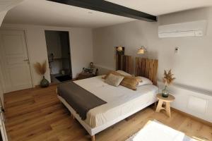 a bedroom with a large bed in a room at Maison classée 5 étoiles à 3km de la mer - Wine and Kite in Torreilles +10 photos