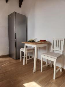 La cuisine est équipée d'une table, de chaises et d'un réfrigérateur. dans l'établissement HOUSE SAL Y MAR, à Arrieta