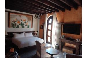 Кровать или кровати в номере Hotel Boutique Posada De Las Flores Loreto