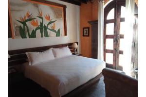 Кровать или кровати в номере Hotel Boutique Posada De Las Flores Loreto