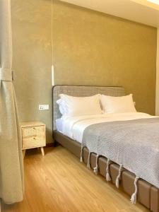 een slaapkamer met een groot bed met witte kussens bij Attitude Resort Langkawi in Pantai Cenang
