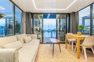 a living room with a couch and a table at The Homeboat Company Parque das Nações-Lisboa in Lisbon