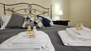 a bedroom with a bed with towels on it at La Locanda Del Castello 