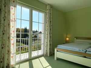 - une chambre avec un lit et une grande fenêtre dans l'établissement Dreimädelshaus, à Uhldingen-Mühlhofen