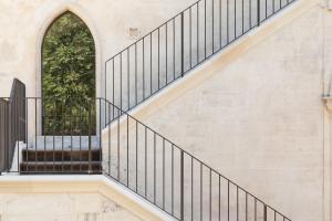 a staircase with black railings and a window at Villa Boscarino Boutique Hotel & Spa in Ragusa
