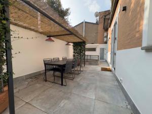 a patio with a table and chairs on it at Realkasa Charming Luxury Apt. in Bologna