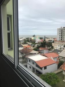 a view of a city from a window at Apt- Suíte - Quadra mar - Aeroporto/Beto Carreiro in Navegantes