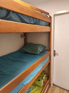 a couple of bunk beds in a room with a door at Super Sauze charmant studio en bas des pistes in Enchastrayes +12 photos