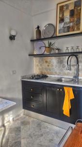 a kitchen with a sink and a counter top at Lella Zohra, Studio avec Piscine à Sidi Bou Said in Sidi Bou Saïd