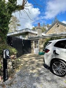 a white car parked in front of a house at Penbontbren Luxury Bed and Breakfast in Aberporth