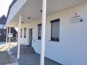 a white building with a sign on the side of it at Eichbachgasse 38 in Graz +2 photos