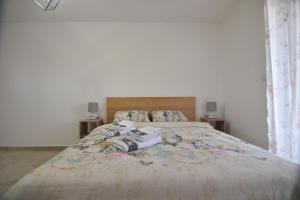 a bedroom with a bed with two cameras on it at Brvnara Mont 2 in Zlatibor