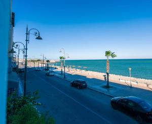 a street with cars parked on the beach at PLAYA Hôtel & Restaurant Dakhla in Dakhla