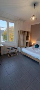 Un dormitorio con una cama y una mesa dentro. en Sirius - SILS, en Caen