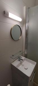 a bathroom with a sink and a mirror at Sirius - SILS in Caen