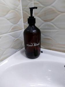 a black soap bottle sitting on top of a sink at Polea Hapa in Ngong