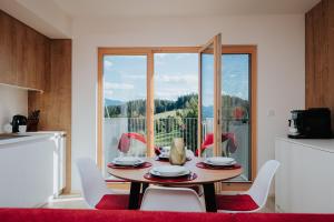 a dining room with a table and chairs and a window at Apartmán Collin X41 in Dolný Kubín
