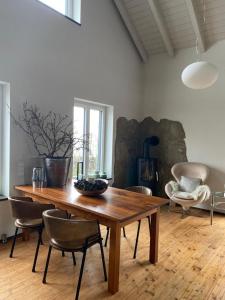 a dining room with a wooden table and chairs at Colle Divino in Würzburg