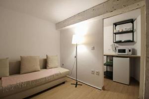 a living room with a couch and a lamp in it at Vivienda en el Centro de Santander in Santander