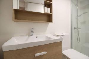 a bathroom with a white sink and a shower at Vivienda en el Centro de Santander in Santander